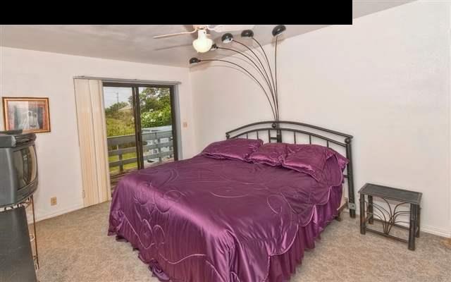 950 Akoa Place Haiku, HI 96708 - Photo 10 of 25 a bedroom with a bed and a window