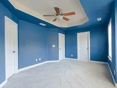 a view of an empty room with a ceiling fan