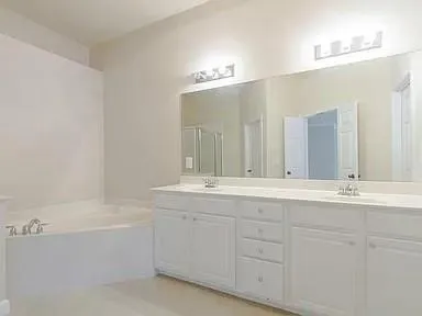 a bathroom with a bathtub and a sink