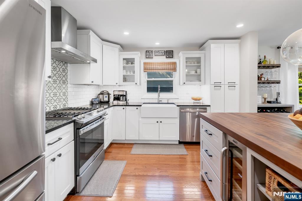 433 Piermont Road Cresskill, NJ 07626 - Photo 12 of 49 a kitchen with a sink stove and cabinets