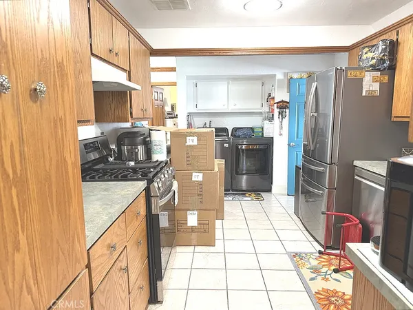 a kitchen with stainless steel appliances granite countertop a refrigerator and a stove