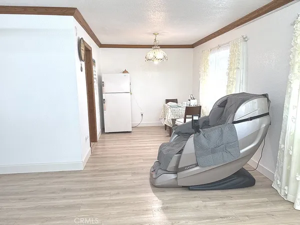 a living room with couches and a coffee table with wooden floor