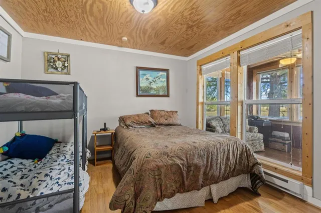 a bedroom with a bed and glass door