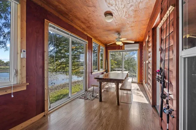 a view of a porch with furniture and wooden floor