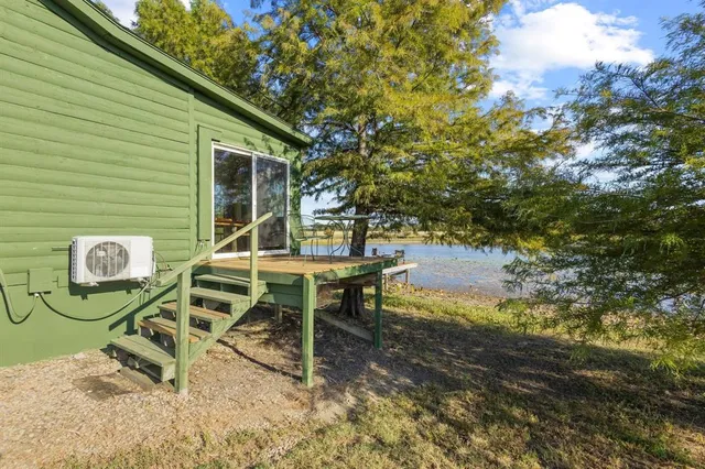 a view of a chairs and table in the backyard