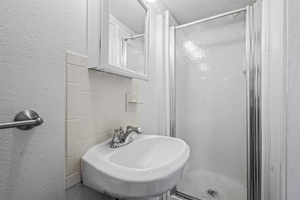300 County Road Roxton, TX 75477 - Photo 24 of 37 a bathroom with a sink and a mirror