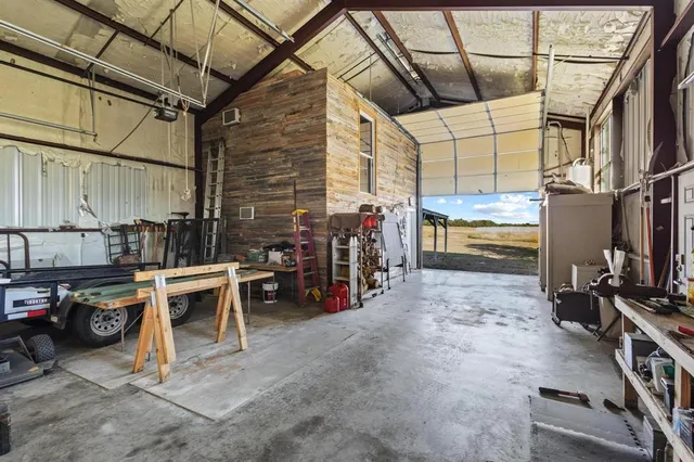 a bedroom with a bed and a chair with the view of bathroom