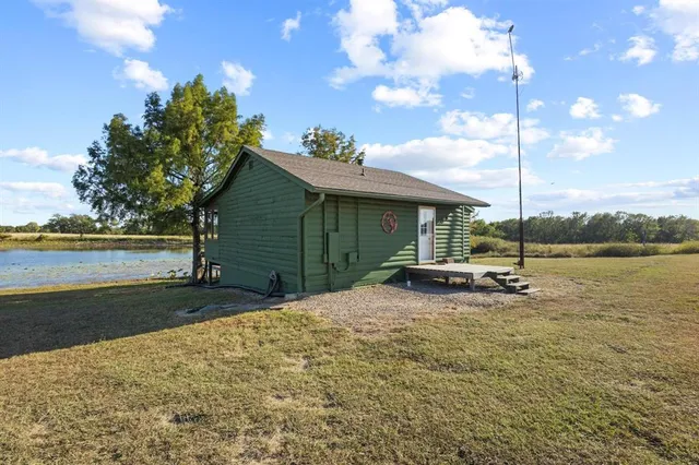 a view of a house with a yard and a patio