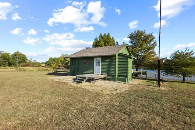 a view of a house with backyard porch and sitting area