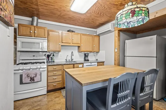 a kitchen with stainless steel appliances granite countertop a stove a refrigerator and a microwave