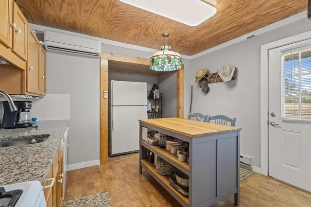 a kitchen that has a stove and a table in it