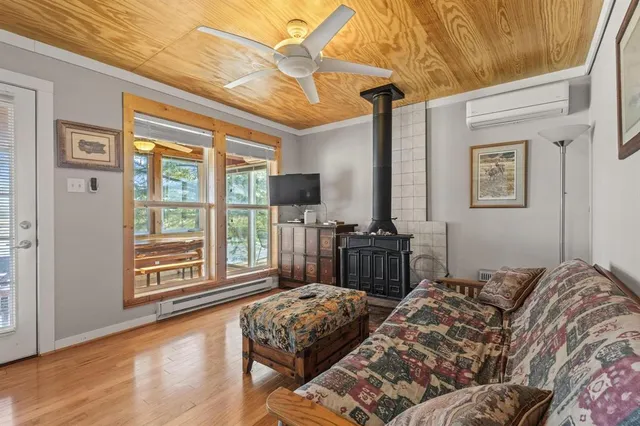 a bedroom with a bed and a dresser next to a window