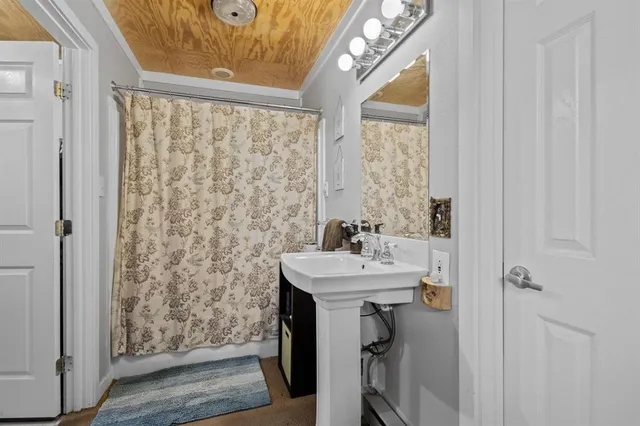 a bathroom with a sink a mirror and shower