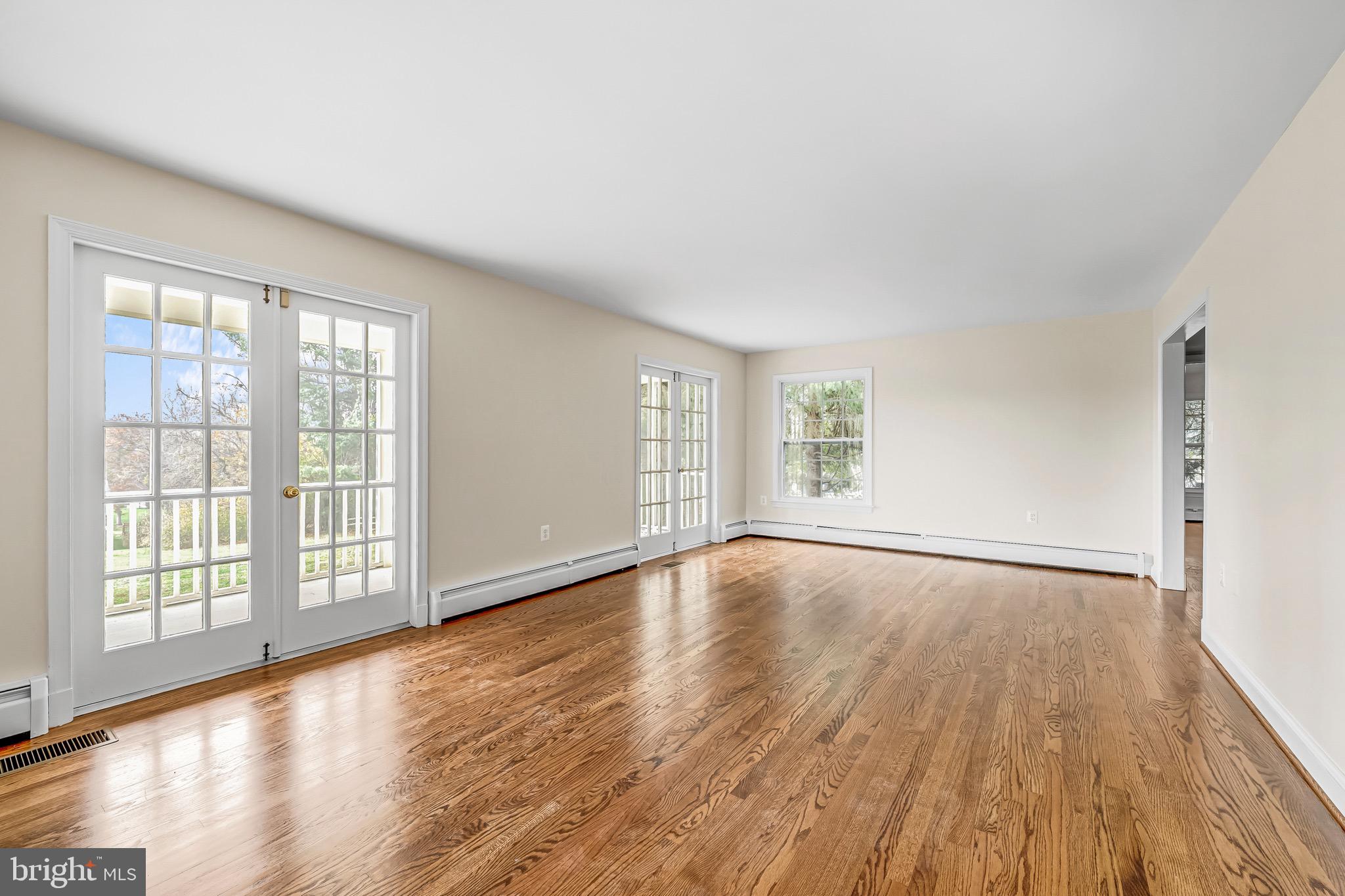 17747 Silcott Springs Road Purcellville, VA 20132 - Photo 19 of 42 a view of an empty room with wooden floor and a window