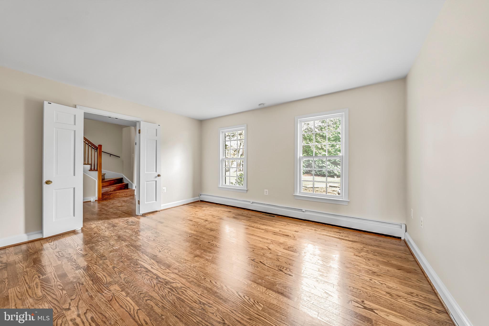 17747 Silcott Springs Road Purcellville, VA 20132 - Photo 20 of 42 a view of an empty room with wooden floor and a window