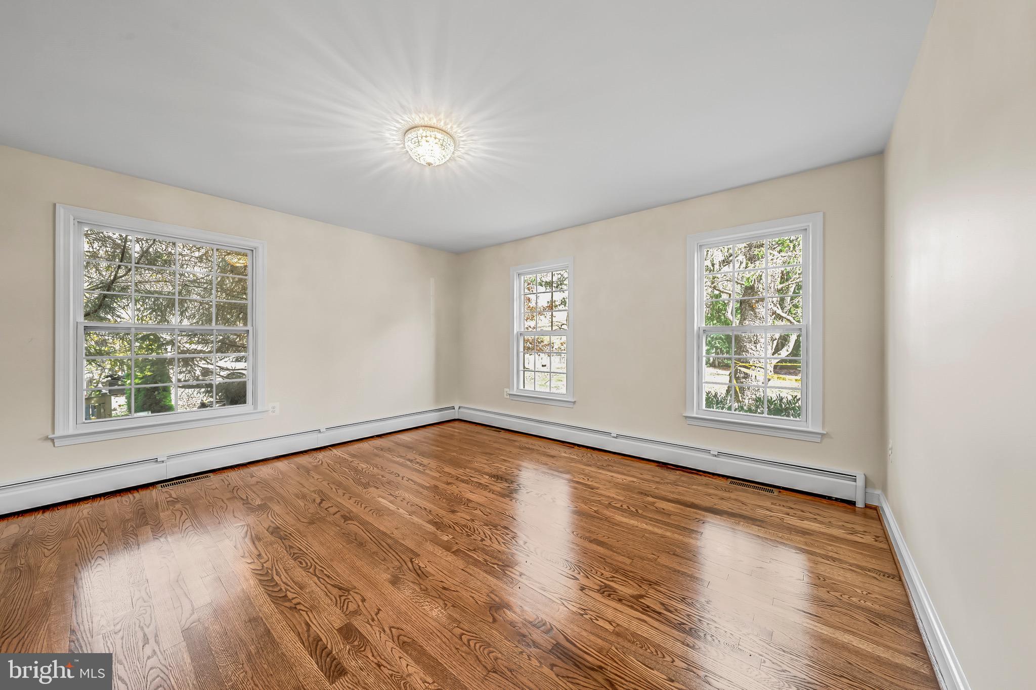 17747 Silcott Springs Road Purcellville, VA 20132 - Photo 22 of 42 a view of an empty room with wooden floor and a window