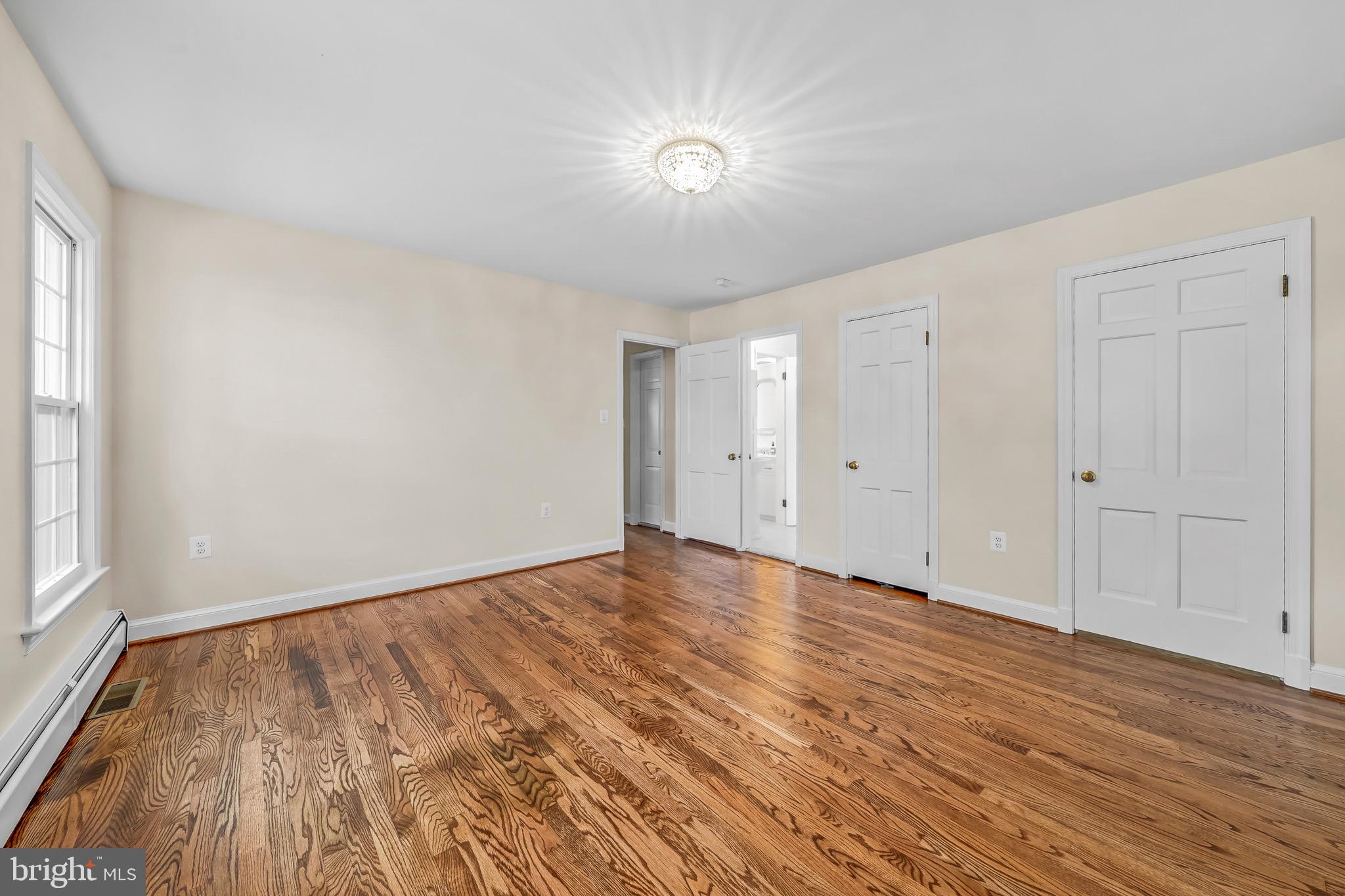 17747 Silcott Springs Road Purcellville, VA 20132 - Photo 24 of 42 an empty room with wooden floor and windows