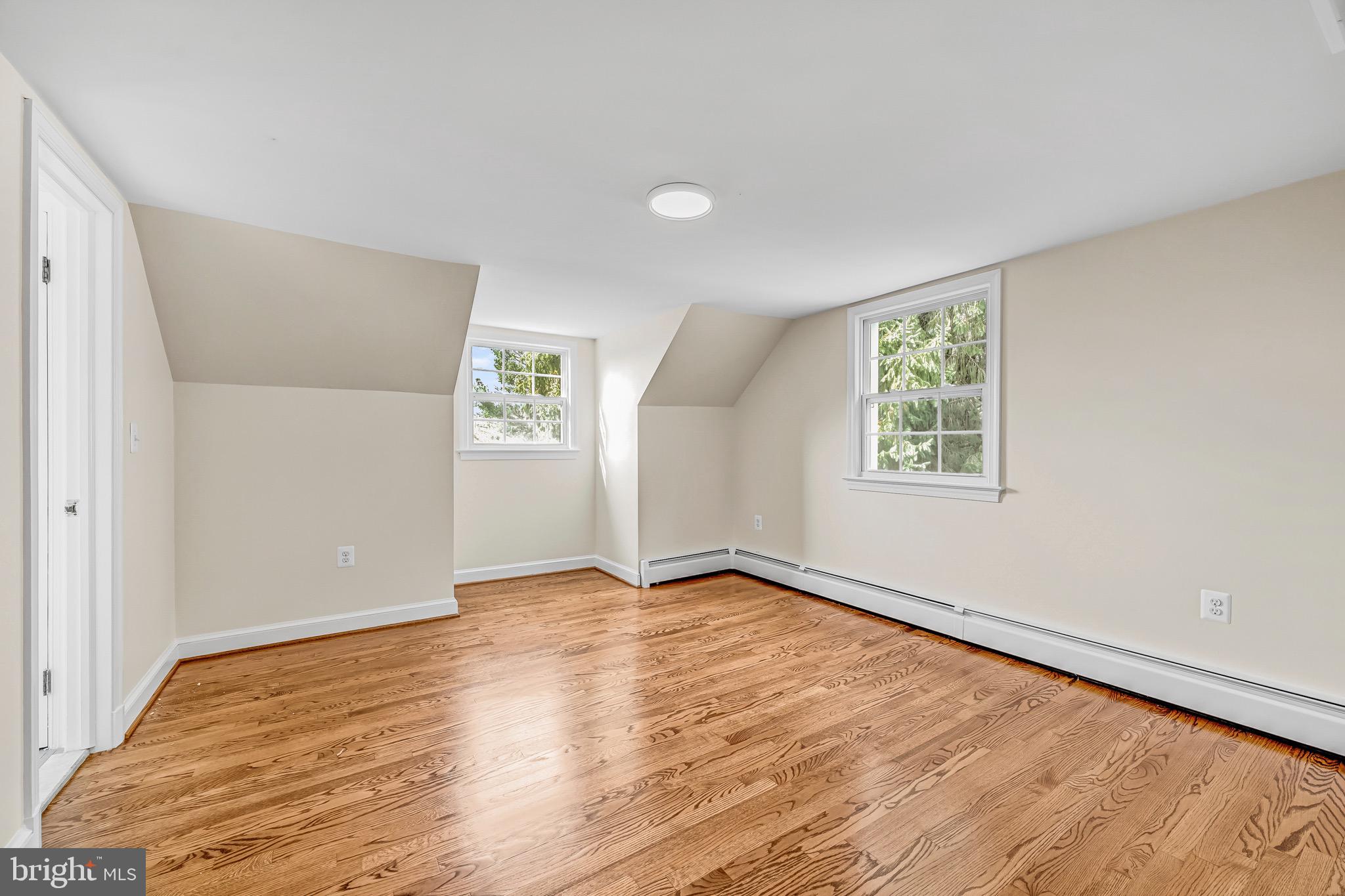 17747 Silcott Springs Road Purcellville, VA 20132 - Photo 31 of 42 an empty room with wooden floor and windows