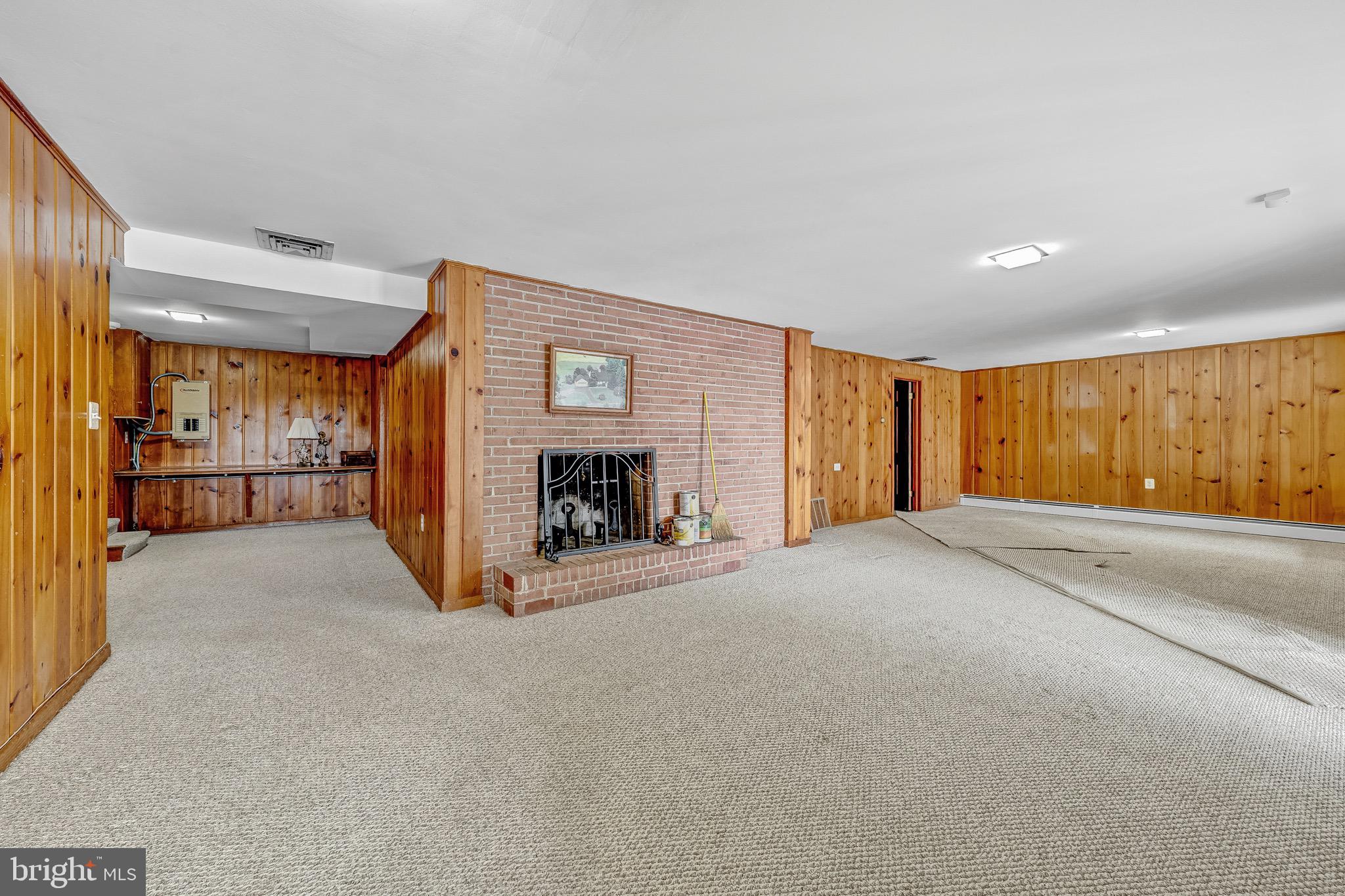 17747 Silcott Springs Road Purcellville, VA 20132 - Photo 33 of 42 a view of an empty room with a fireplace and a window