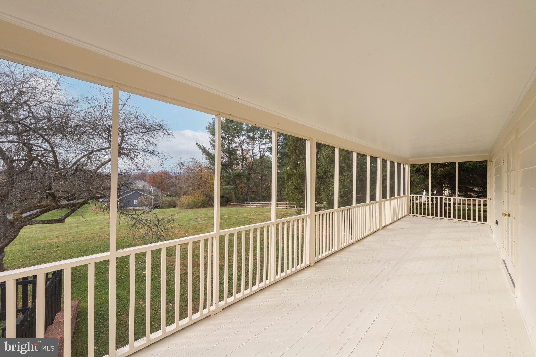 17747 Silcott Springs Road Purcellville, VA 20132 - Photo 40 of 42 a view of balcony with floor to ceiling window and wooden fence