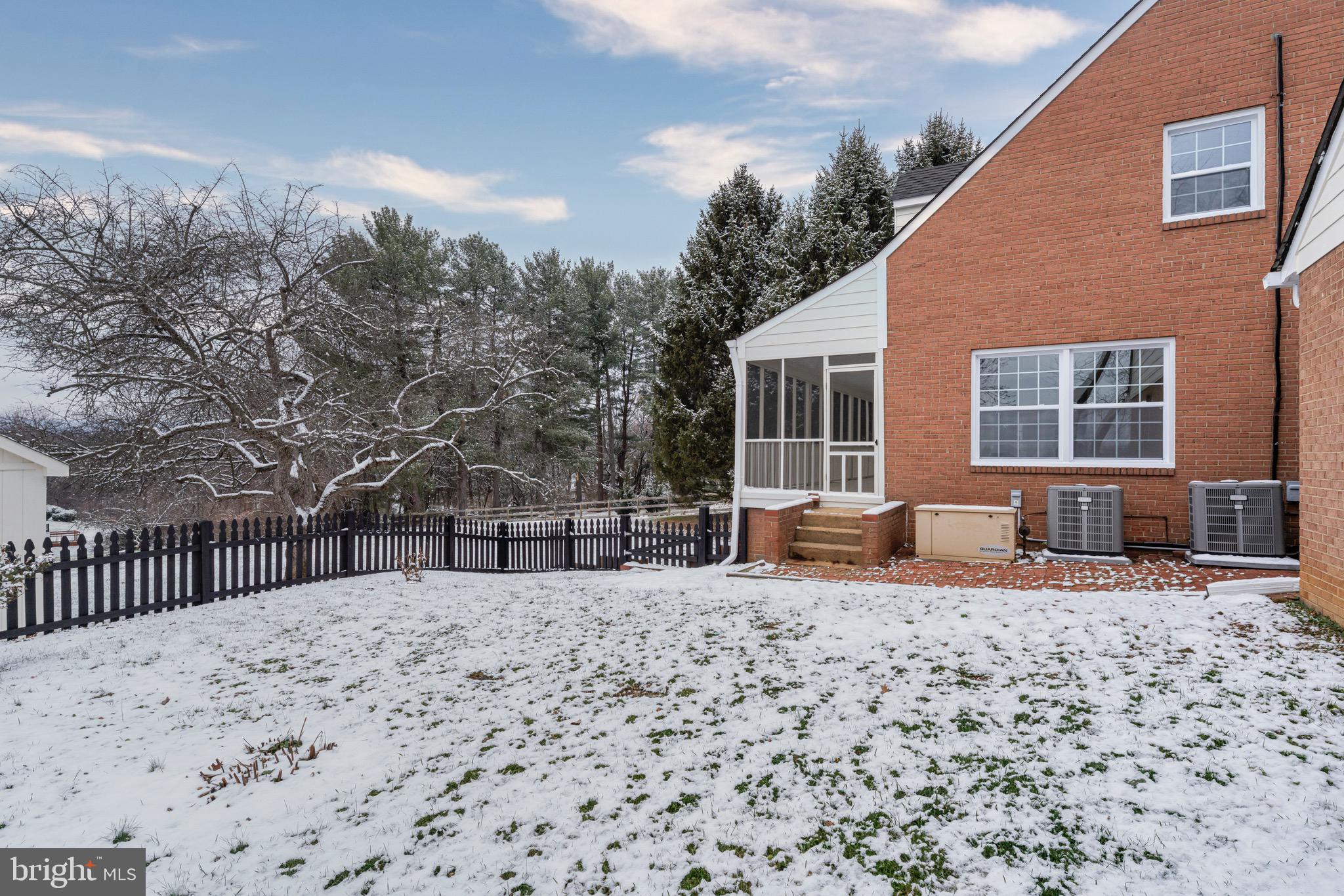 17747 Silcott Springs Road Purcellville, VA 20132 - Photo 5 of 42 a backyard of a house with large trees and wooden fence