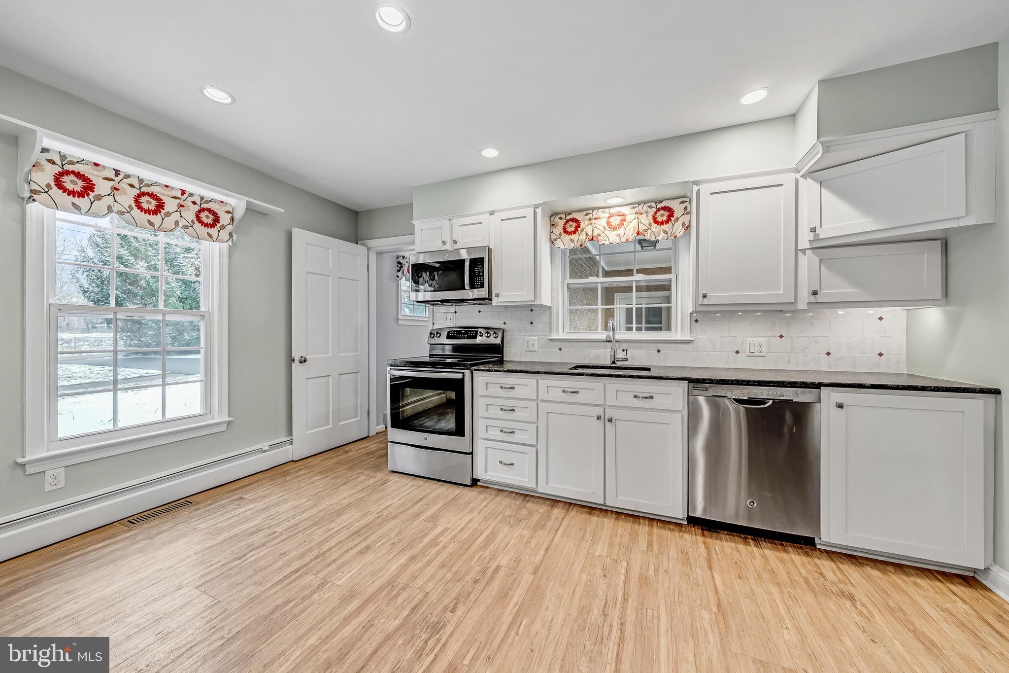 17747 Silcott Springs Road Purcellville, VA 20132 - Photo 10 of 42 a kitchen with stainless steel appliances granite countertop a stove a sink and a microwave