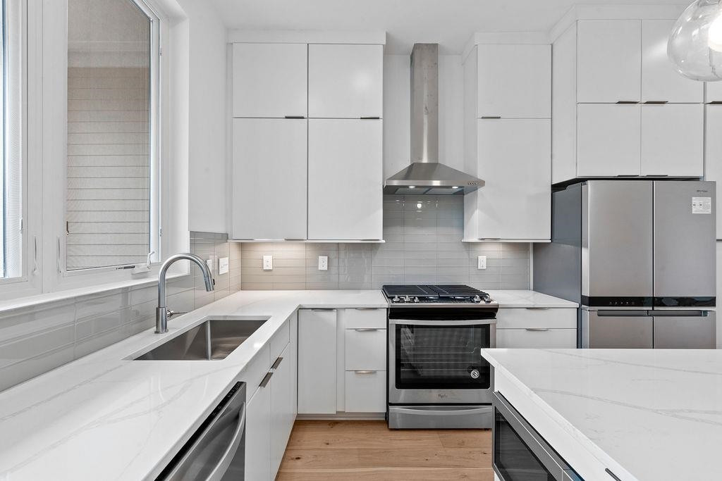310 Mallard Avenue Durham, NC 27701 - Photo 12 of 41 a kitchen with a sink and white cabinets