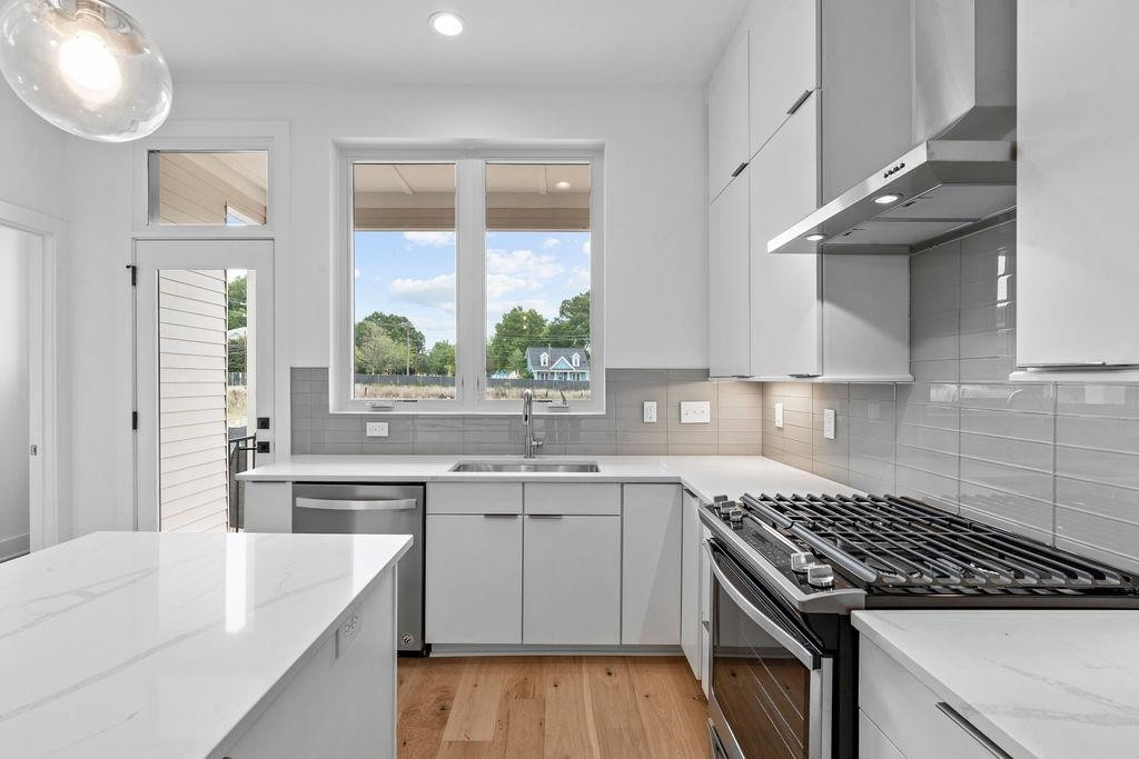 310 Mallard Avenue Durham, NC 27701 - Photo 13 of 41 a kitchen with a sink stove and cabinets
