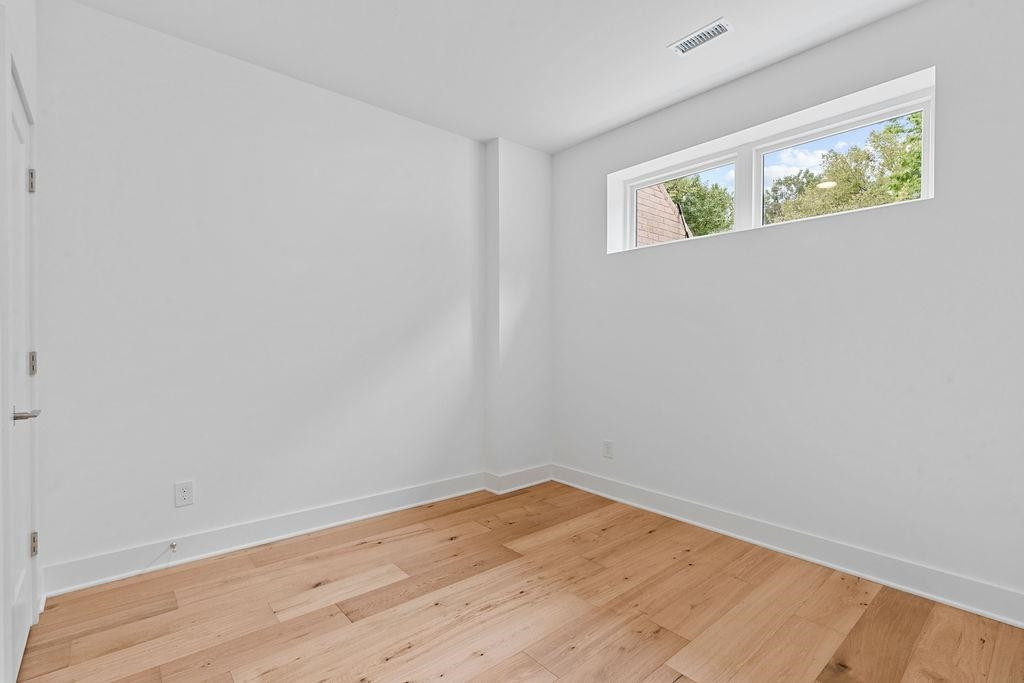 310 Mallard Avenue Durham, NC 27701 - Photo 16 of 41 a view of an empty room with wooden floor and a window