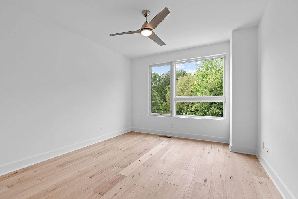 310 Mallard Avenue Durham, NC 27701 - Photo 21 of 41 a view of empty room with wooden floor and fan