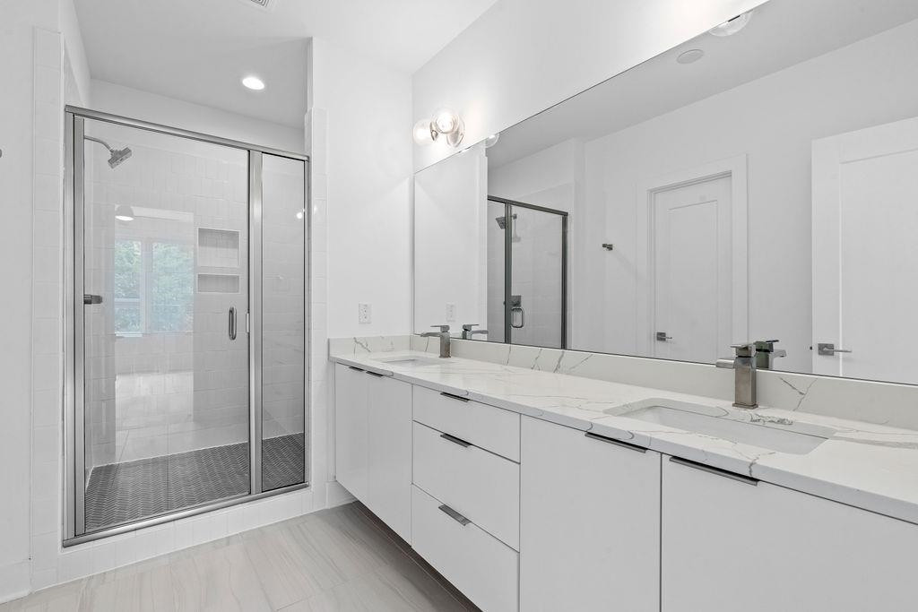 310 Mallard Avenue Durham, NC 27701 - Photo 23 of 41 a bathroom with a shower sink and mirror