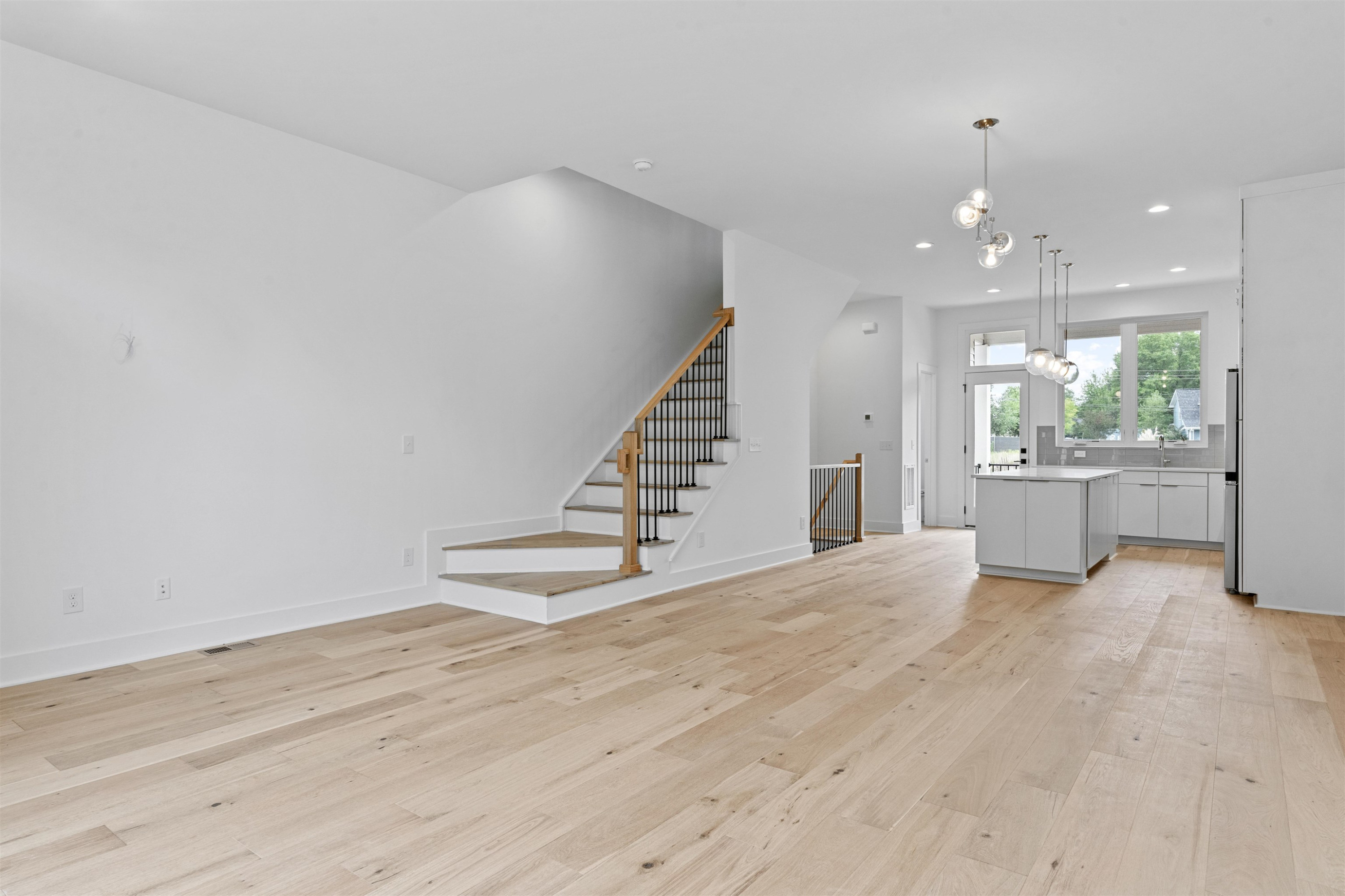 310 Mallard Avenue Durham, NC 27701 - Photo 7 of 41 wooden floor in an empty room with a kitchen