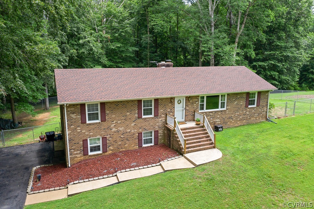 9441 Trails End Road Midlothian, VA 23112 - Photo 36 of 40 a front view of a house with a garden