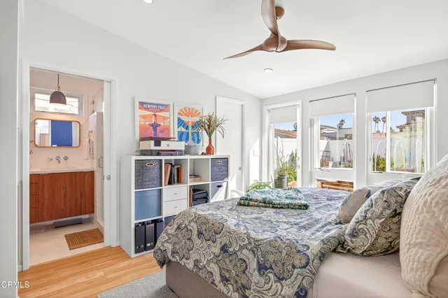 a large bed sitting in a bedroom next to a large window