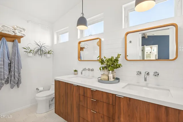 a bed room with a bed mirror and a window