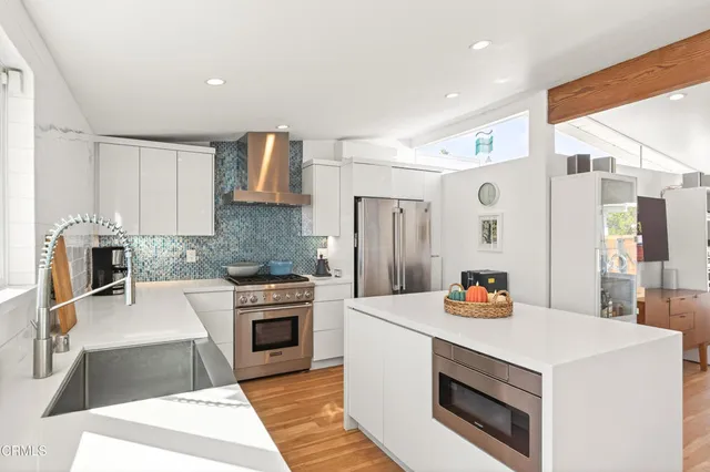 a kitchen with a stove a sink and a refrigerator