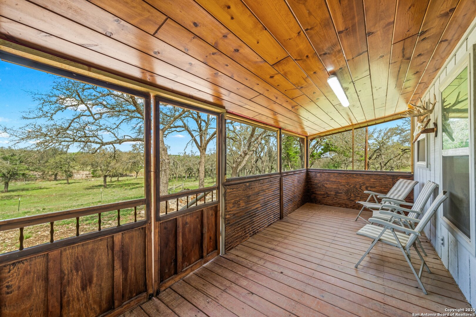 563 J B Road Harper, TX 78631 - Photo 16 of 41 a view of a balcony with chairs and wooden floor