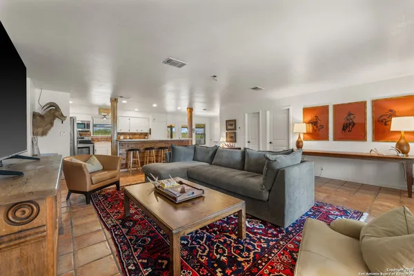 a living room with furniture a rug and a flat screen tv