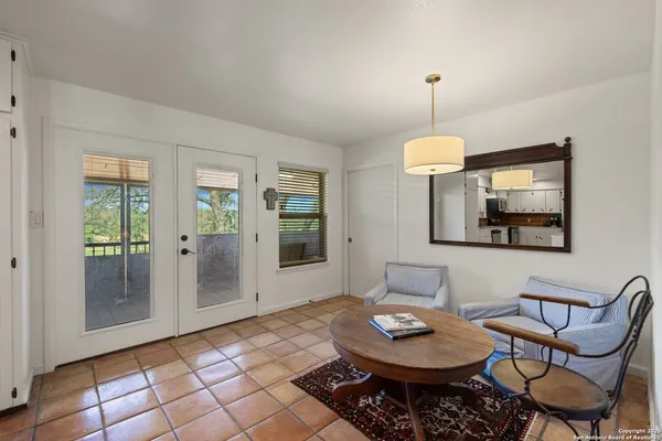 a living room with furniture a window and a table
