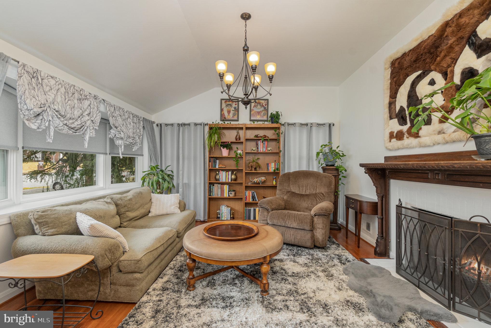 1406 Shefford Road Baltimore, MD 21239 - Photo 10 of 33 a living room with furniture a chandelier and a rug