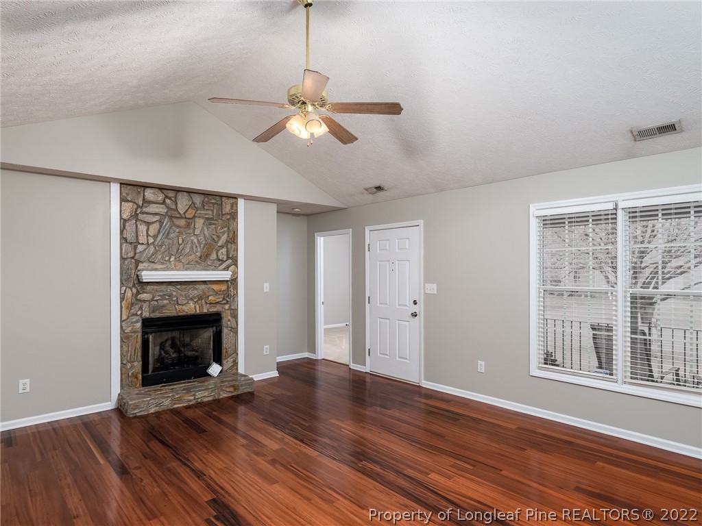 847 Turkey Ridge Drive Fayetteville, NC 28314 - Photo 14 of 31 a view of an empty room with wooden floor fireplace and a window
