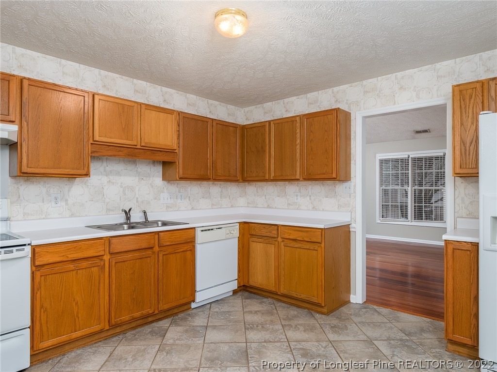 847 Turkey Ridge Drive Fayetteville, NC 28314 - Photo 16 of 31 a kitchen with a sink and cabinets