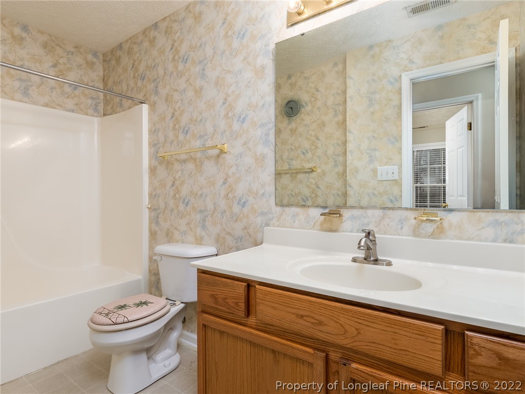 847 Turkey Ridge Drive Fayetteville, NC 28314 - Photo 20 of 31 a bathroom with a sink a toilet and shower