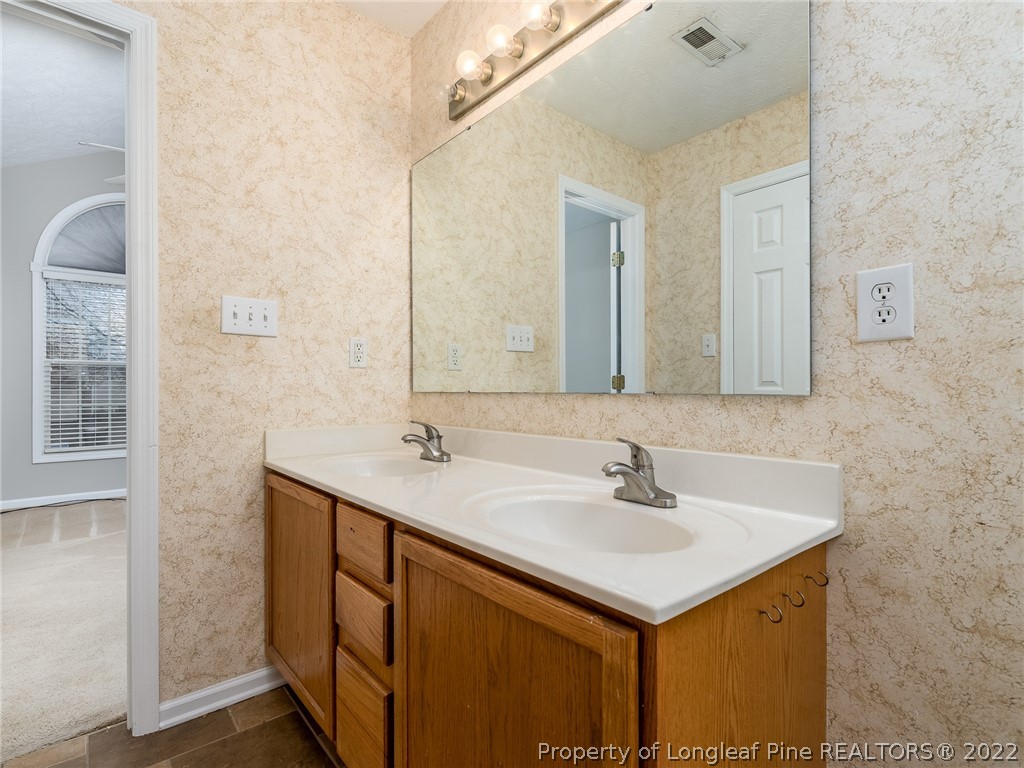 847 Turkey Ridge Drive Fayetteville, NC 28314 - Photo 25 of 31 a bathroom with a sink and a mirror