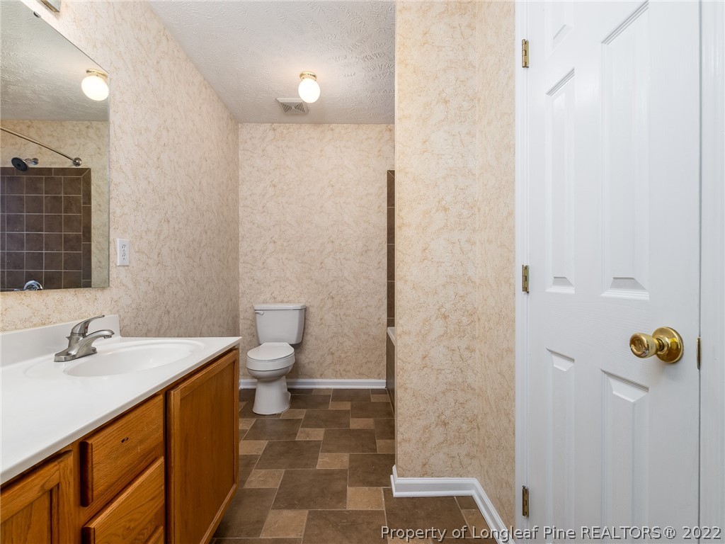 847 Turkey Ridge Drive Fayetteville, NC 28314 - Photo 26 of 31 a bathroom with a sink a toilet and shower