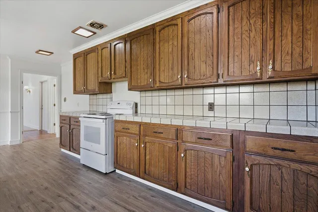 an empty room with windows and fireplace