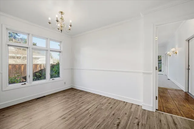 a kitchen with stainless steel appliances granite countertop a stove a sink dishwasher and a refrigerator with wooden floor