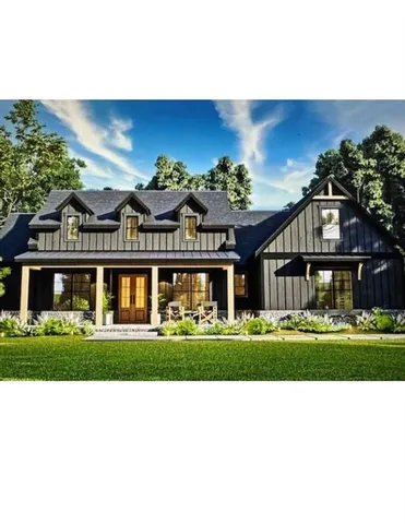 a black and white building with a big yard