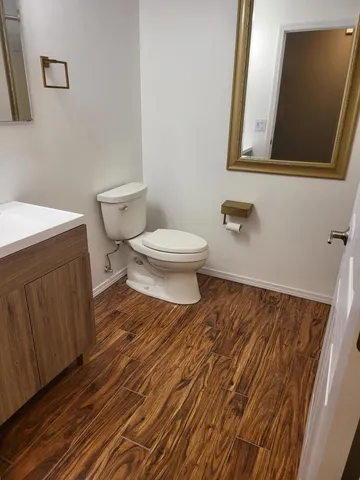 a bathroom with a toilet and a mirror