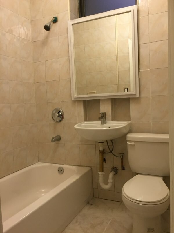 518 Bainbridge Street, Unit 1B Brooklyn, NY 11233 - Photo 6 of 7 a bathroom with a sink a toilet and bathtub